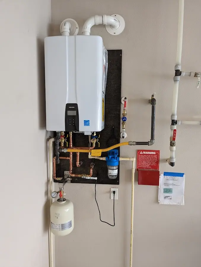 Professional plumber installing copper piping in a Mechanicsburg home